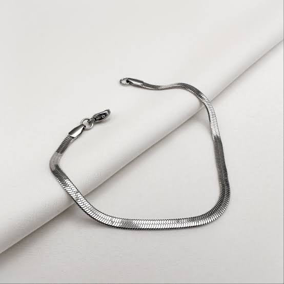 Silver snake chain necklace on a light gray background