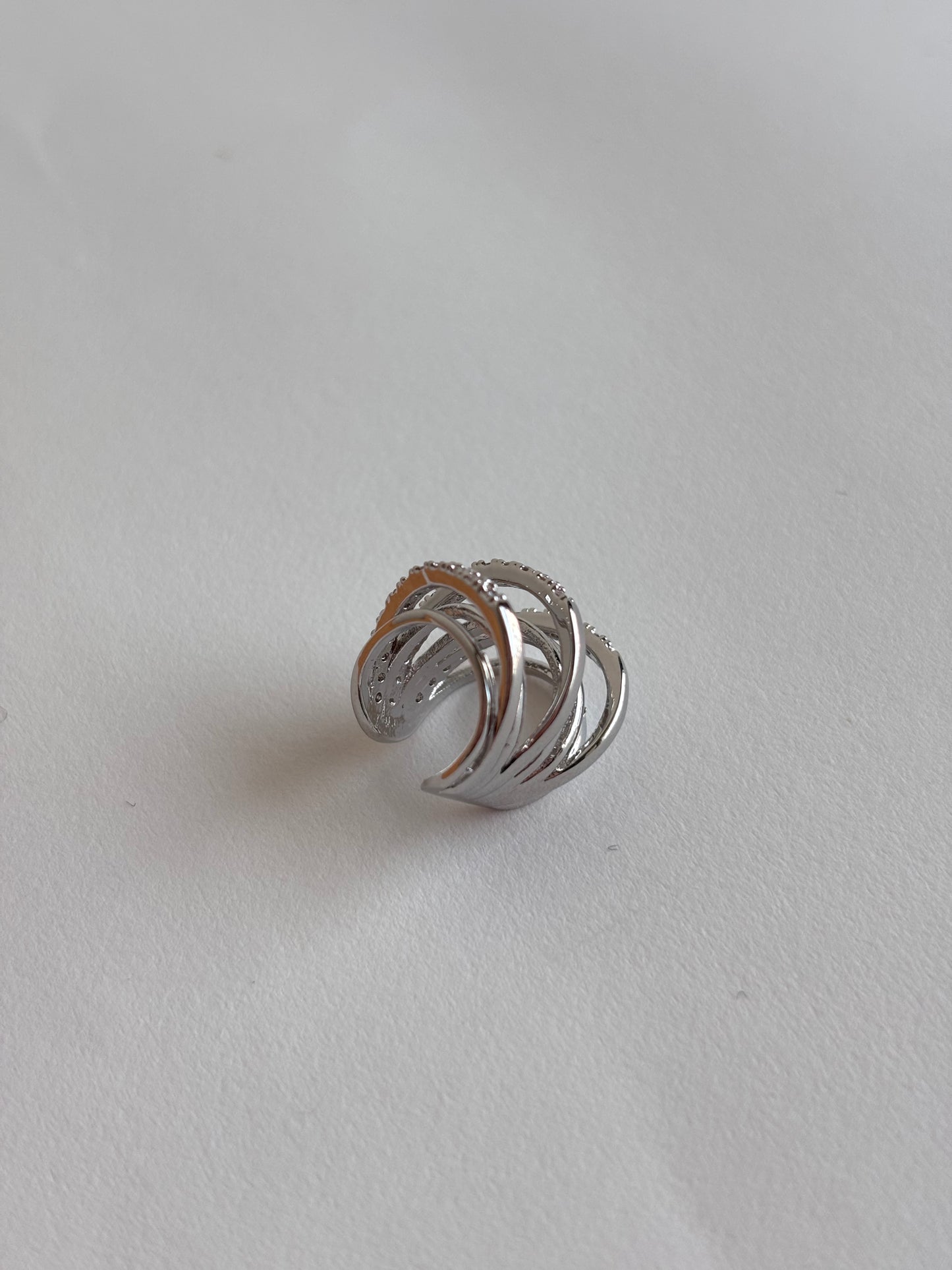 Silver ear cuff that requires no piercing  on a light gray background